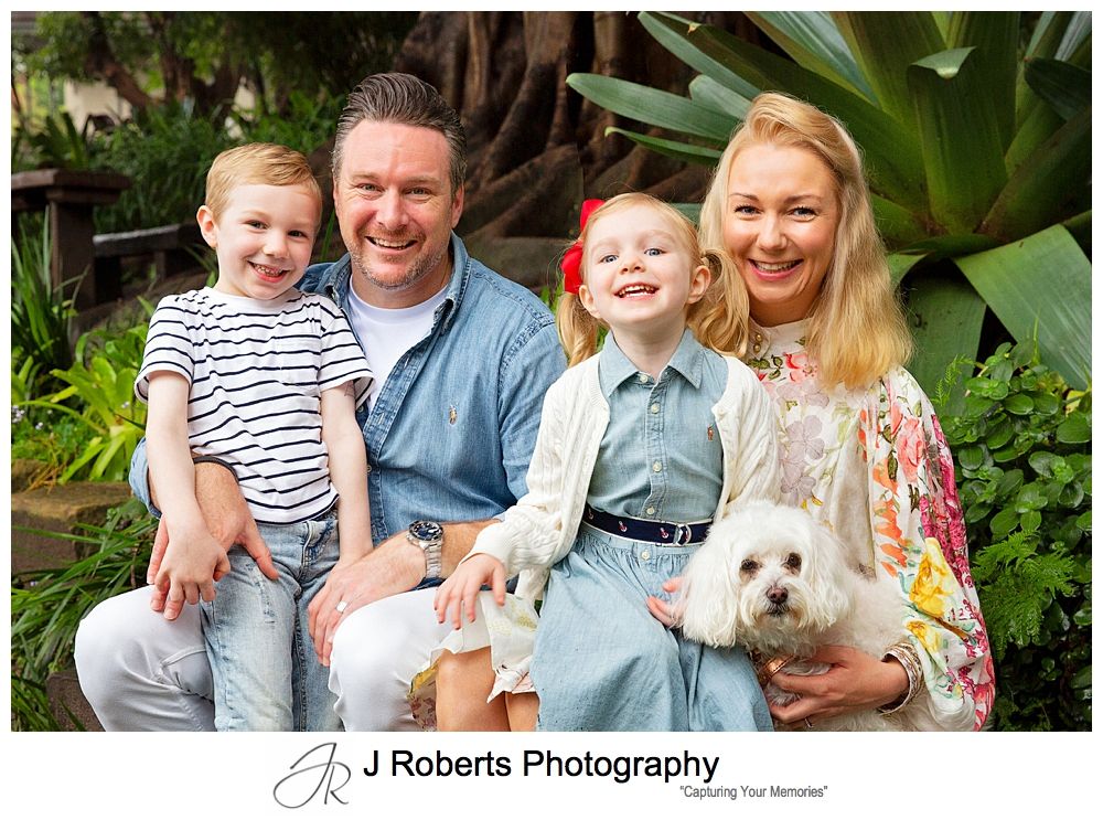 Family portrait fun in the rain in Sydney gumboots and umbrellas Wendy Whiteleys Garden Lavender Bay